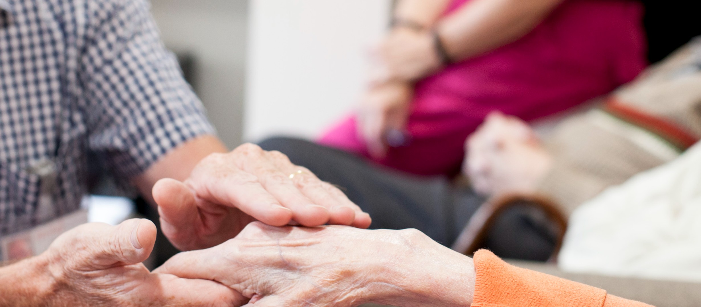 Someone gently touching someone's hand