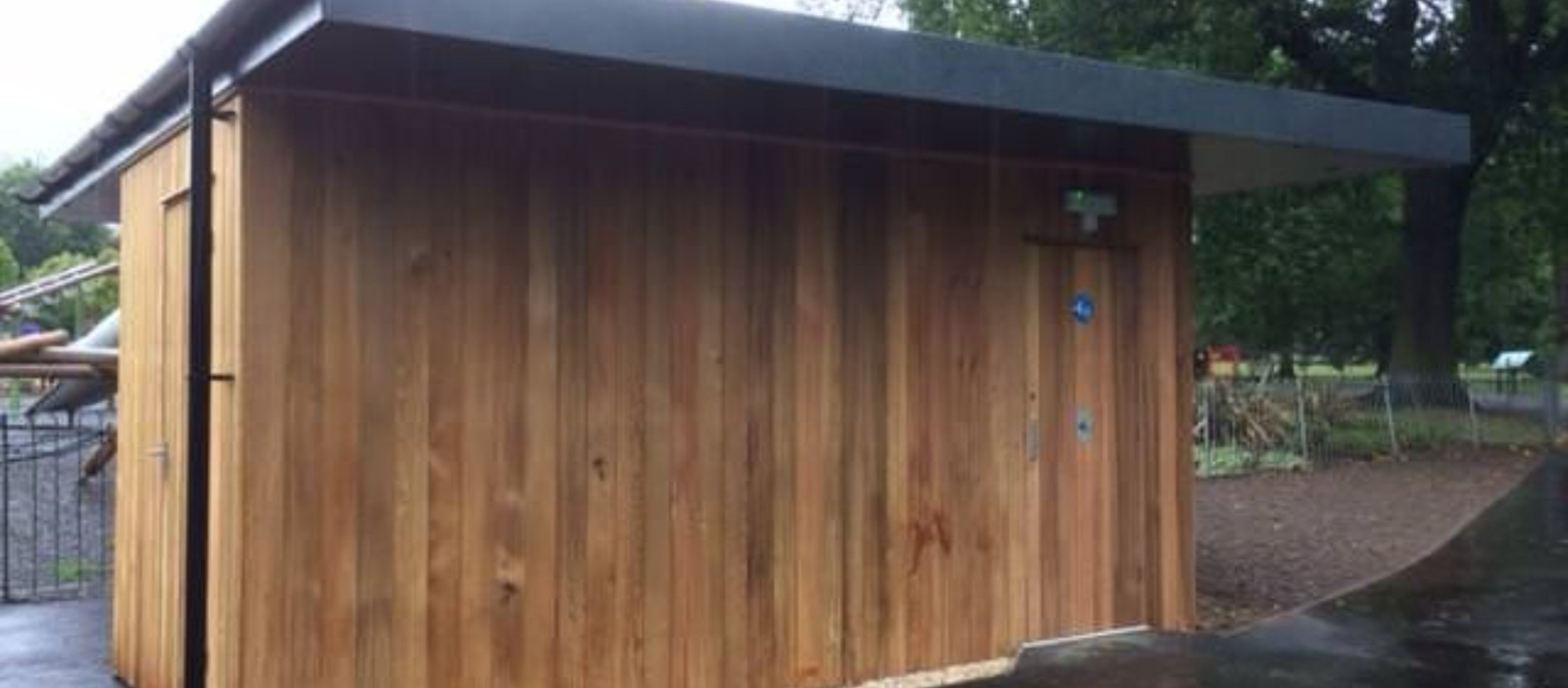 Wooden cabin with Changing Places Logo