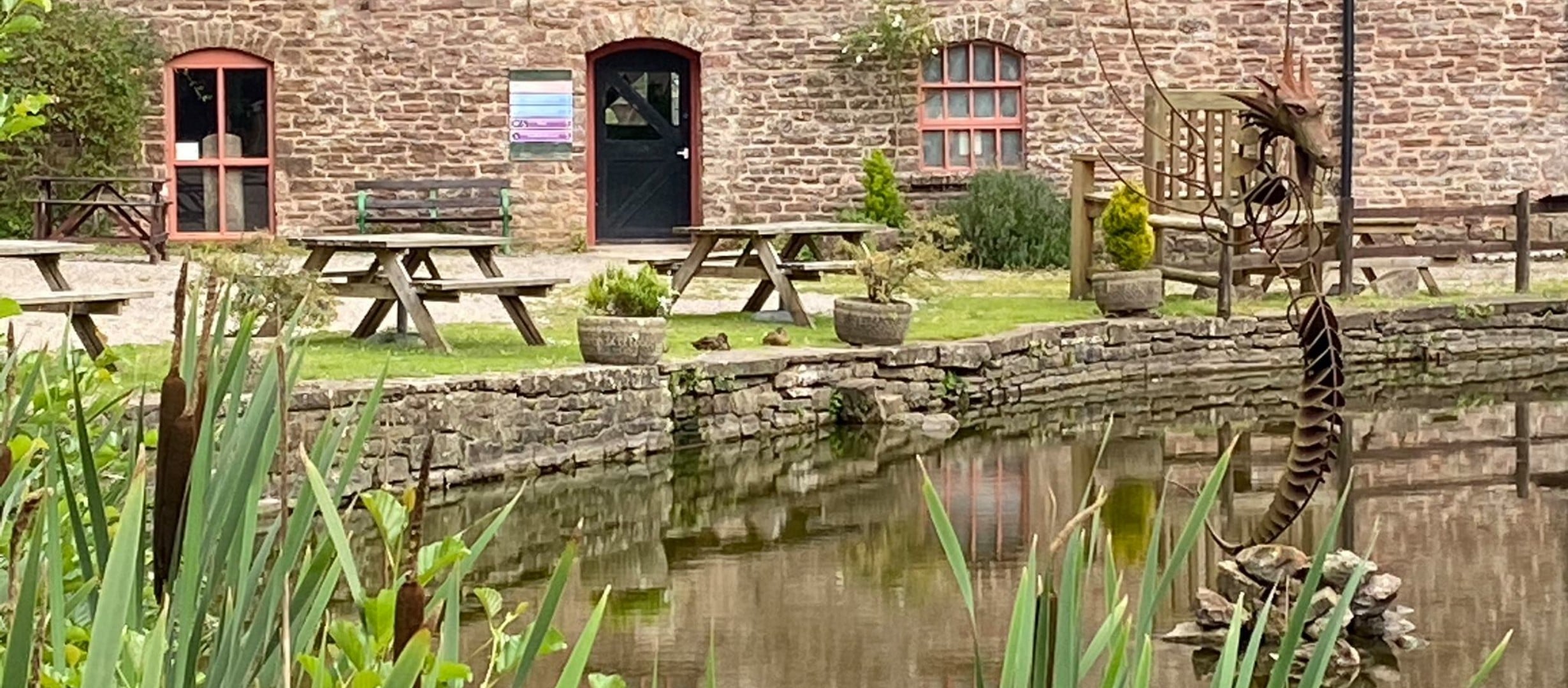 view over millpond towards mill building