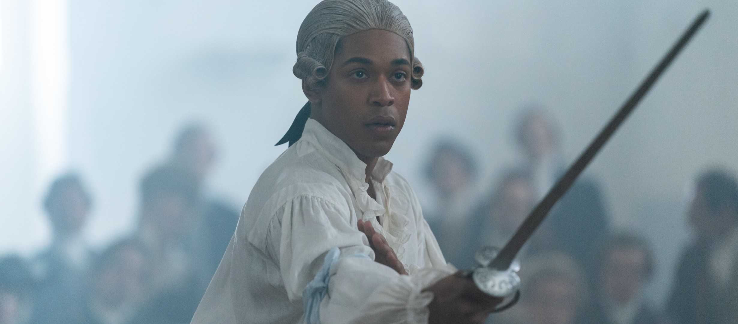 A man in 18th century attire holding a sword