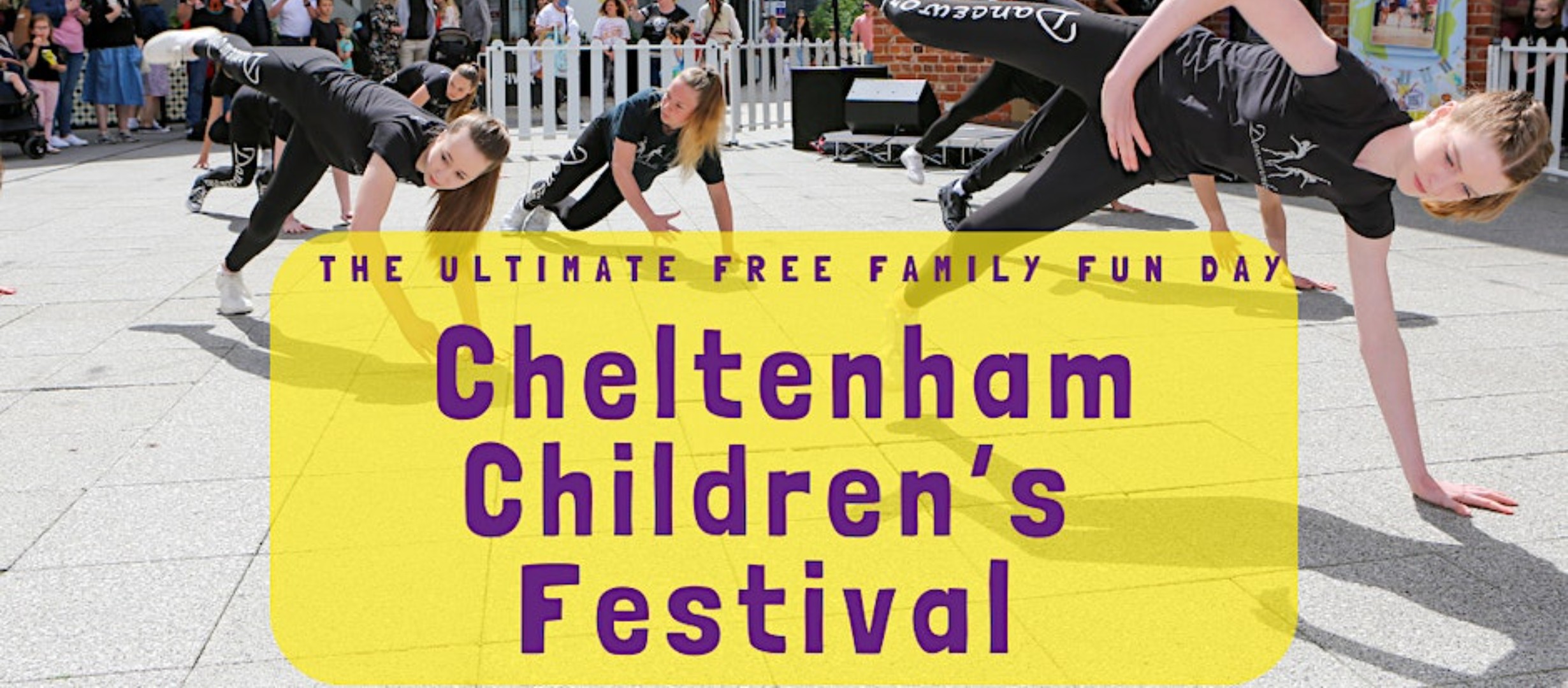 Title of event with dancers performing in the background