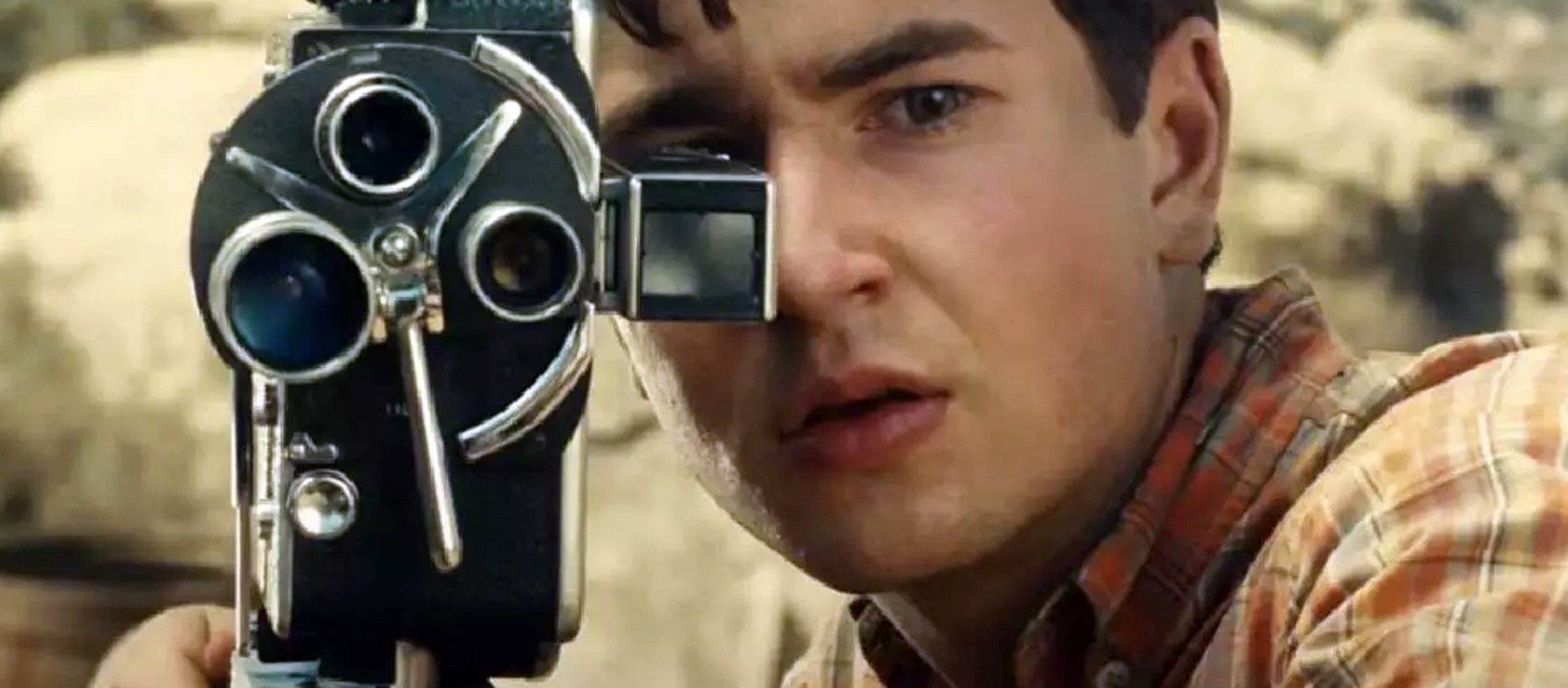 Person looking through an old film camera