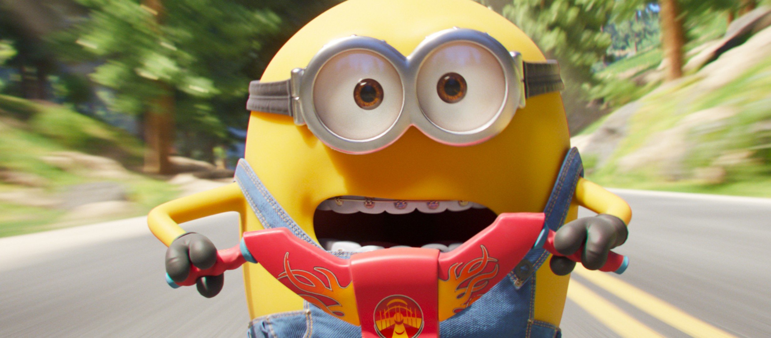 A little yellow creature riding a motorbike