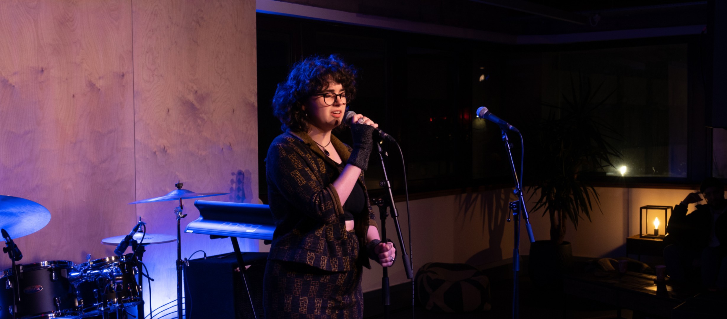 Young artist performing on stage at The Music Works Hub at one of our UPSURGE Live events.