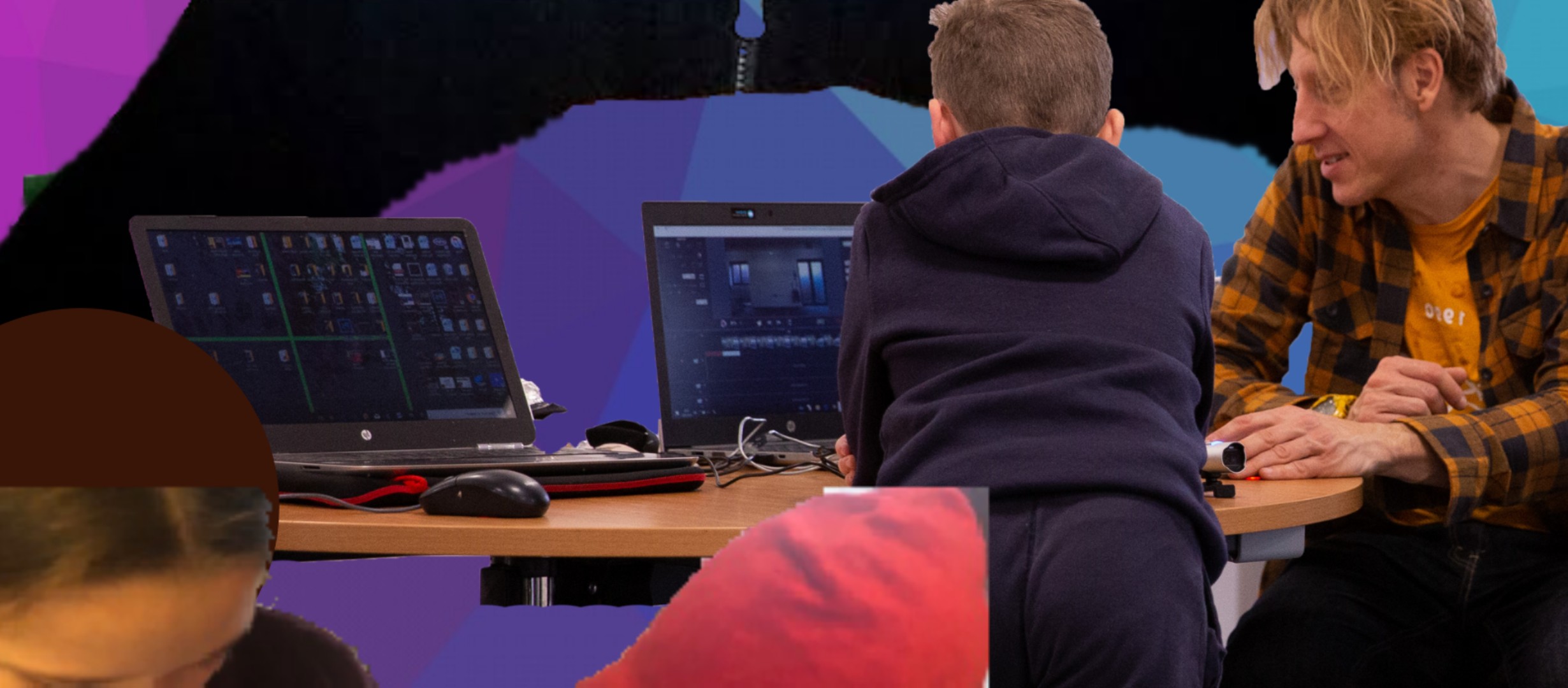 Young person and adult looking at two computers on a table