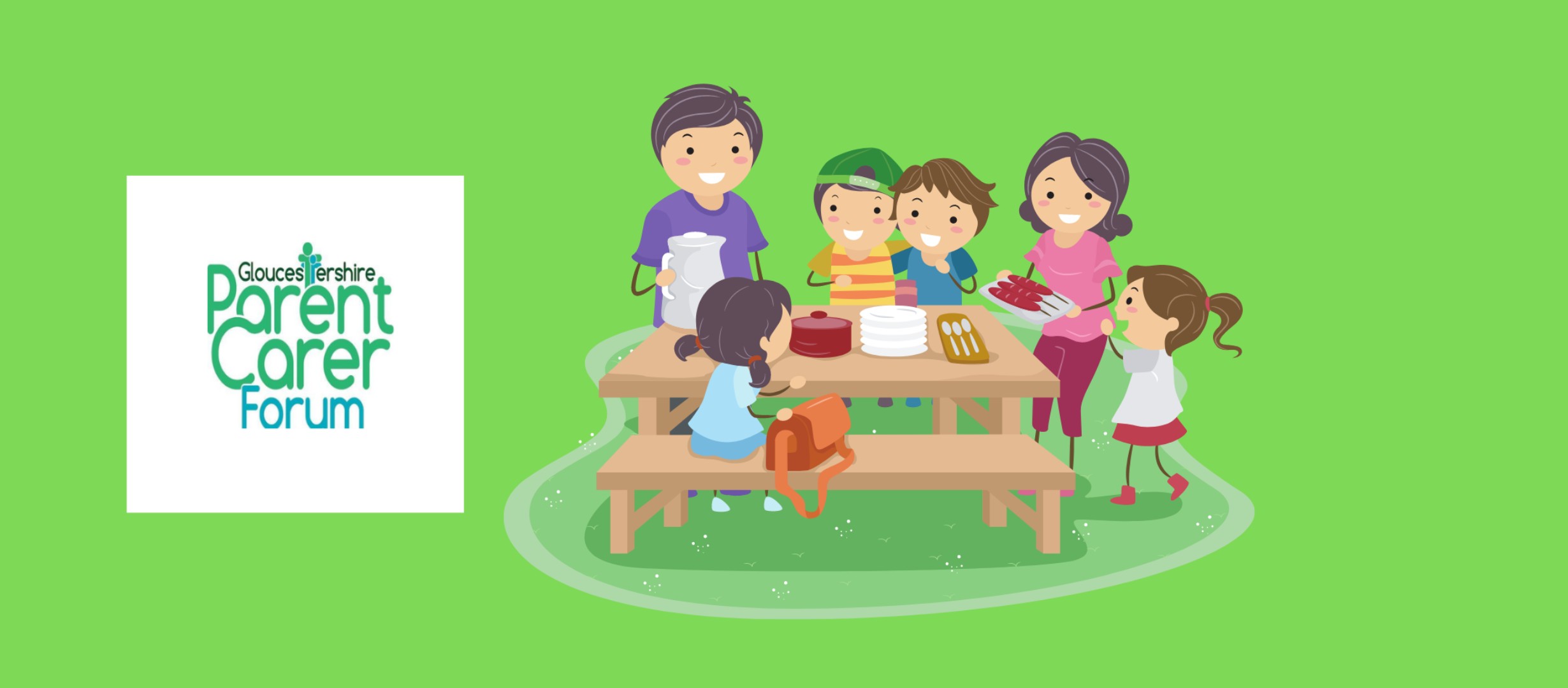 children sit around a picnic table smiling