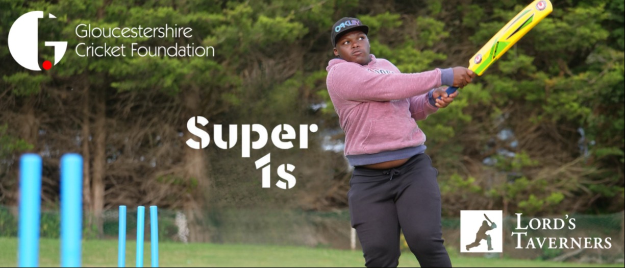 Cricket player in pink jumper hitting a cricket ball with a yellow bat