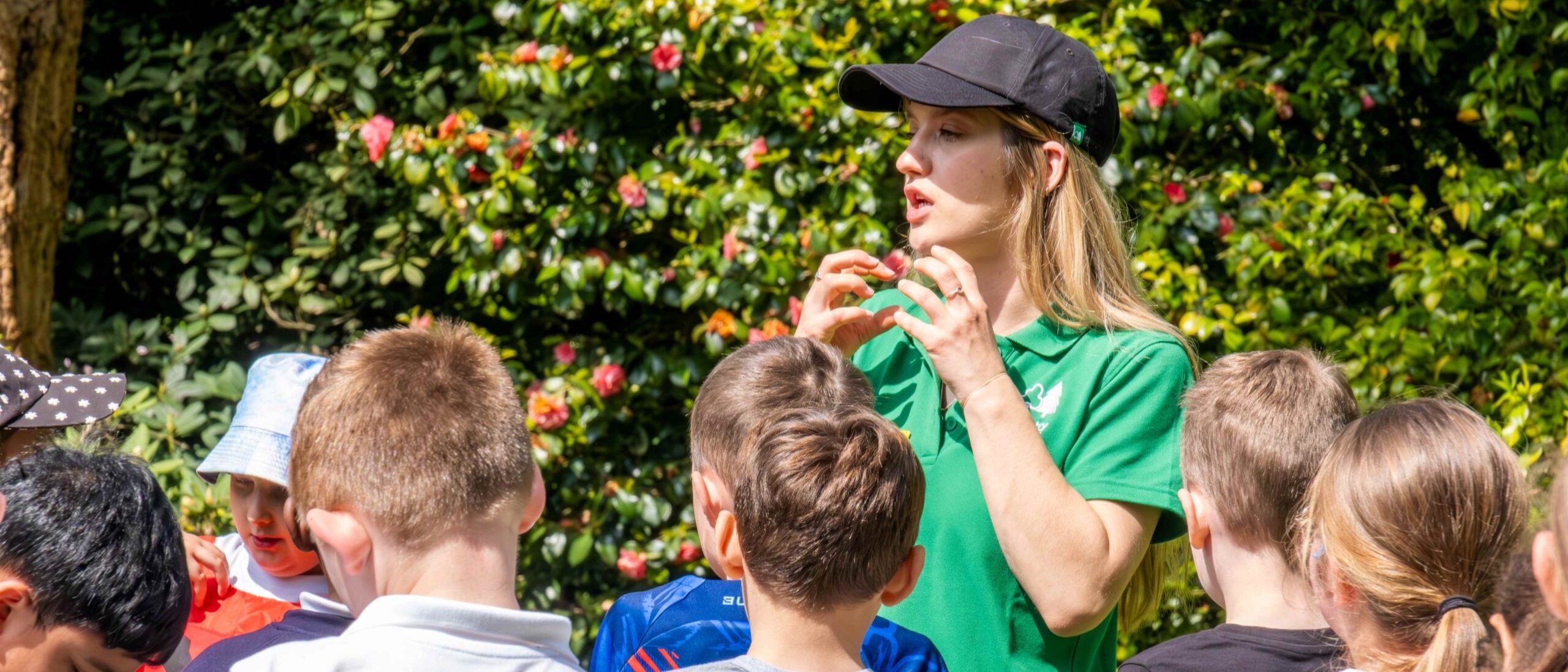 children gathered outside listening to activity guide