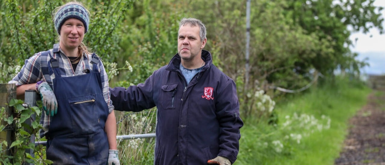 photo of a woman and a man in the countryside